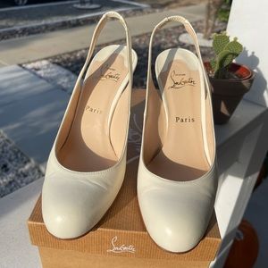 Cream Christian Louboutin heels with red bottoms